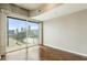 Bedroom with wood floors, concrete ceilings and city view through a large window at 361 17Th Nw St # 1001, Atlanta, GA 30363