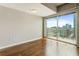 Sun-lit bedroom featuring hardwood floors, a modern ceiling light, and a balcony with stunning city views at 361 17Th Nw St # 1001, Atlanta, GA 30363