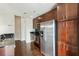 Kitchen featuring stainless steel appliances, dark backsplash, and dark wood cabinets at 361 17Th Nw St # 1001, Atlanta, GA 30363