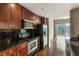 Modern kitchen featuring stainless steel appliances, dark backsplash, and hardwood flooring at 361 17Th Nw St # 1001, Atlanta, GA 30363