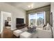 Modern living room with city views, a plush white sofa, sleek furnishings, and a glimpse into the bedroom at 361 17Th Nw St # 1001, Atlanta, GA 30363