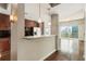 Open-concept living area featuring hardwood floors, concrete pillar, and a kitchen with granite countertops at 361 17Th Nw St # 1001, Atlanta, GA 30363