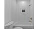 Bright bathroom with a white tiled shower, a black tile accent, and gold fixtures at 159 Shadburn Ferry Rd, Buford, GA 30518