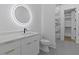 Modern bathroom with an illuminated round mirror and stylish vanity at 159 Shadburn Ferry Rd, Buford, GA 30518