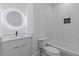 Elegant bathroom featuring a modern vanity, illuminated mirror, and a tiled shower with gold accents at 159 Shadburn Ferry Rd, Buford, GA 30518