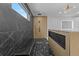 Modern bathroom showcasing a large walk-in shower with black marble and a built-in bench at 159 Shadburn Ferry Rd, Buford, GA 30518