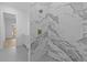 Elegant bathroom with marble shower and gold fixtures, and tiled floors at 159 Shadburn Ferry Rd, Buford, GA 30518
