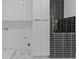 Modern bathroom featuring sleek black tiling, gold shower fixtures, and stylish geometric floor tiles at 159 Shadburn Ferry Rd, Buford, GA 30518