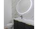 Stylish bathroom with modern vanity, backlit mirror and marble accent wall at 159 Shadburn Ferry Rd, Buford, GA 30518