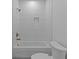Bathroom shower featuring vertical white tiles and bronze fixtures at 159 Shadburn Ferry Rd, Buford, GA 30518