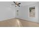 Bright, airy bedroom featuring a ceiling fan, hardwood floors, and large windows at 159 Shadburn Ferry Rd, Buford, GA 30518