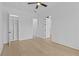 Bright bedroom featuring hardwood floors, walk-in closet, and white doors at 159 Shadburn Ferry Rd, Buford, GA 30518