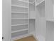 Large, organized walk-in closet with built-in shelving and ample storage space at 159 Shadburn Ferry Rd, Buford, GA 30518