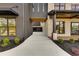 Modern home exterior featuring a driveway leading to a garage, showcasing sleek design and manicured landscaping at 159 Shadburn Ferry Rd, Buford, GA 30518