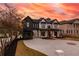 Striking two-story home featuring a brick and dark siding exterior and expansive driveway and manicured yard at 159 Shadburn Ferry Rd, Buford, GA 30518