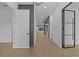 Bright hallway showcasing hardwood floors, modern lighting fixtures, and an open floor plan at 159 Shadburn Ferry Rd, Buford, GA 30518