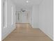 Long hallway with hardwood floors, crisp white trim, and a ceiling fan at 159 Shadburn Ferry Rd, Buford, GA 30518