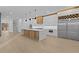 Bright, modern kitchen featuring a large island, stainless steel appliances, and wood accents at 159 Shadburn Ferry Rd, Buford, GA 30518
