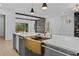 Modern kitchen island with gold hardware, sink and view to outdoor space at 159 Shadburn Ferry Rd, Buford, GA 30518