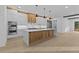 Kitchen with large island, modern appliances and access to back yard at 159 Shadburn Ferry Rd, Buford, GA 30518