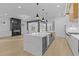 Kitchen with large center island, stainless steel appliances, open to living room at 159 Shadburn Ferry Rd, Buford, GA 30518