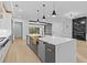 Kitchen with a large island, custom cabinets, and modern stainless steel appliances at 159 Shadburn Ferry Rd, Buford, GA 30518