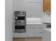 Modern kitchen featuring double ovens, and sleek cabinetry at 159 Shadburn Ferry Rd, Buford, GA 30518