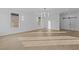 Living area features light wood floors, modern light fixture and paneled accent wall at 159 Shadburn Ferry Rd, Buford, GA 30518