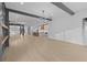 Open-concept view of the living area into the kitchen, featuring hardwood floors at 159 Shadburn Ferry Rd, Buford, GA 30518