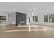 This open-concept living area features hardwood floors, modern lighting, and a sleek fireplace feature at 159 Shadburn Ferry Rd, Buford, GA 30518