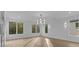 Bright living room features hardwood floors, recessed lighting and multiple windows with outdoor views at 159 Shadburn Ferry Rd, Buford, GA 30518