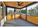 Inviting screened patio with wooden floors, a ceiling fan, and scenic views of the surrounding landscape at 159 Shadburn Ferry Rd, Buford, GA 30518