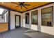 Covered patio showcasing wooden floors, exterior brick accents, and outdoor access at 159 Shadburn Ferry Rd, Buford, GA 30518