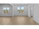 Bright room with light hardwood floors, crisp white trim, with large windows offering outdoor views at 159 Shadburn Ferry Rd, Buford, GA 30518