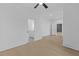 Bright room with light hardwood floors, crisp white trim, with hallway leading to bathroom at 159 Shadburn Ferry Rd, Buford, GA 30518