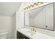 Modern bathroom featuring a black vanity, quartz countertop, and gold faucet and light fixture at 2611 Charlesgate Ave, Decatur, GA 30030