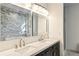 Bright bathroom featuring double vanity, soaking tub, stone accent wall, and marble floors exudes luxury at 2611 Charlesgate Ave, Decatur, GA 30030