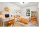 Brightly decorated bedroom featuring white walls, light floors, orange accents and desk at 2611 Charlesgate Ave, Decatur, GA 30030