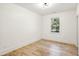 Bright bedroom with light hardwood floors, neutral walls and large window bringing in lots of light at 2611 Charlesgate Ave, Decatur, GA 30030