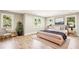 A spacious and bright bedroom with large windows, hardwood floors, and a comfortable seating area at 2611 Charlesgate Ave, Decatur, GA 30030