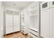 Large walk in closet featuring white shelves, drawers and hardwood floors at 2611 Charlesgate Ave, Decatur, GA 30030