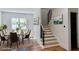 Bright dining room with seating for six, modern art, and a view from the window at 2611 Charlesgate Ave, Decatur, GA 30030