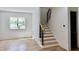 An open-concept hallway featuring hardwood floors and a staircase with black metal railings at 2611 Charlesgate Ave, Decatur, GA 30030