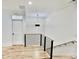 Hallway with hardwood floors, wood and steel railing and modern light fixture exudes contemporary elegance at 2611 Charlesgate Ave, Decatur, GA 30030
