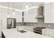 A well lit spacious kitchen with an island, stainless steel refrigerator, and modern appliances at 2611 Charlesgate Ave, Decatur, GA 30030