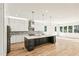 Open-concept kitchen with an oversized center island, pendant lights, and stainless steel appliances at 2611 Charlesgate Ave, Decatur, GA 30030