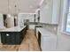 A long view of a modern kitchen with a kitchen island, stainless steel appliances, and white cabinets at 2611 Charlesgate Ave, Decatur, GA 30030