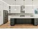 Spacious kitchen featuring white cabinetry, a large island, stainless steel appliances, and modern lighting at 2611 Charlesgate Ave, Decatur, GA 30030