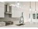 Modern kitchen with stainless steel appliances, white cabinets, an island, and pendant lighting at 2611 Charlesgate Ave, Decatur, GA 30030