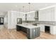 Bright open kitchen featuring an island, modern appliances, custom cabinets, and hardwood floors at 2611 Charlesgate Ave, Decatur, GA 30030